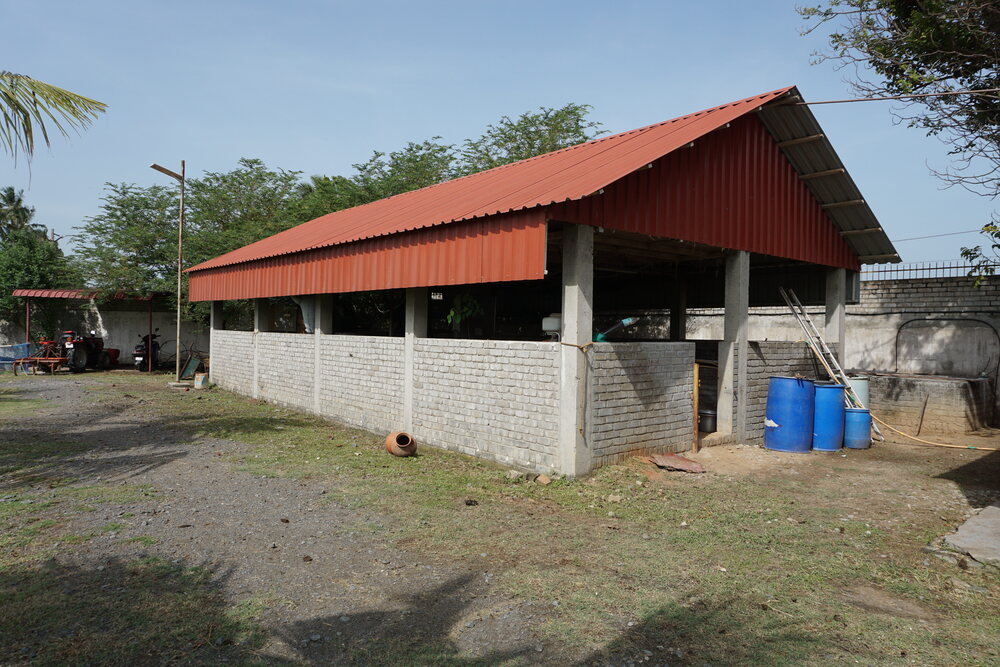 Functional farm shed used for storing tools and equipment.
